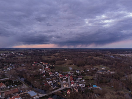 Sunset and storm clouds over the river and city on a spring day.の写真素材