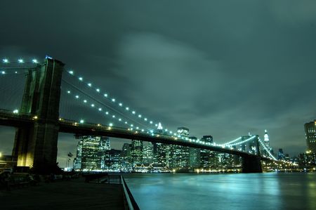 Manhattan skyline and brooklyn bridge at nightの写真素材