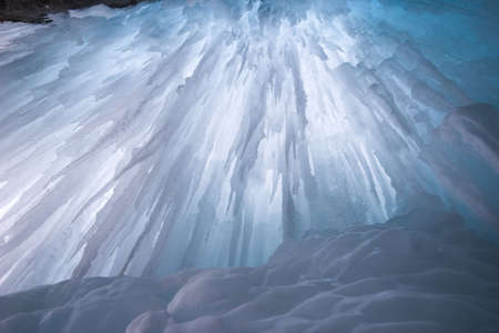 icefall from behind,frozen waterfall shot with tripod, backlit by natural lightの写真素材