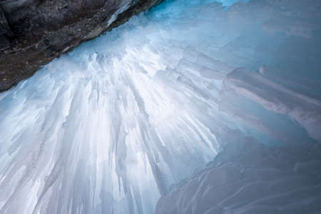 icefall from behind,frozen waterfall shot with tripod, backlit by natural lightの写真素材