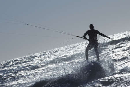 kite surfer surfing a wave in wild waterの写真素材