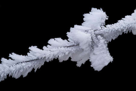 frosty ice crystals on fence in winterの写真素材