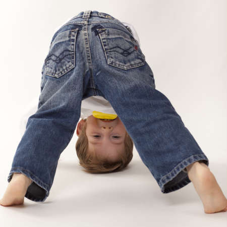 boy playing head down,white studio