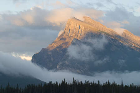 mount rundle in banff national park appearing out of cloudsの写真素材