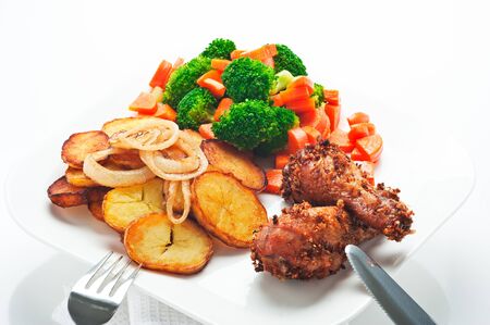 Fried potatoes broccoli carrots and roasted chickenの写真素材