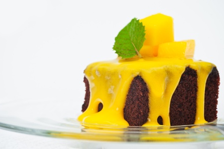 Small cakes with vanilla sauce and mangoの写真素材