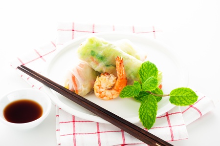 Vegetarian spring roll with carrot, soy sprouts and shrimp on white background as a studio shot