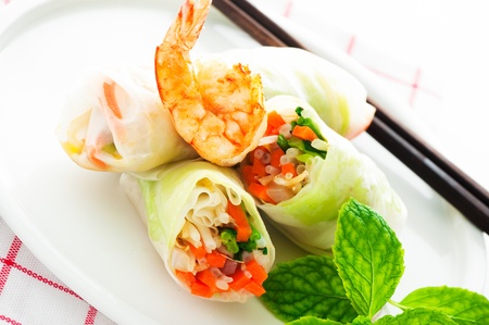 Vegetarian spring roll with carrot, soy sprouts and shrimp on white background as a studio shotの写真素材