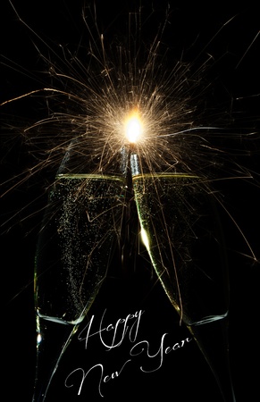 New Year firework celebration with rockets exploding high in the night sky and Happy New Year text belowの写真素材