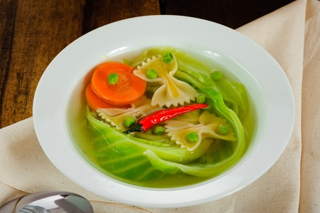 spicy cabbage soup in a white plate on a wood tableの写真素材
