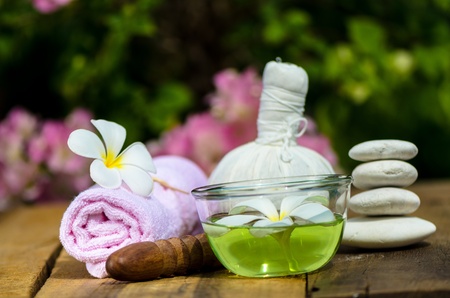 Spa massage setting with thai herbal compress stamps and candlelightの写真素材