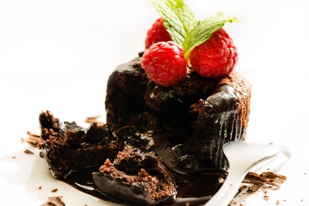 Close up of hot melting chocolate cake dessert with raspberry