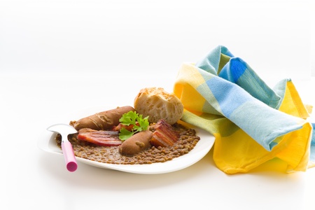 Lentil soup with sausage in plate on white backgroundの写真素材
