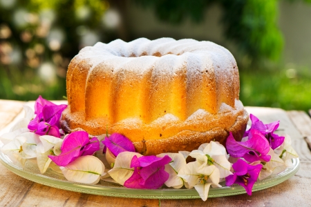bundt cake on plate decorated with flowers and green の写真素材