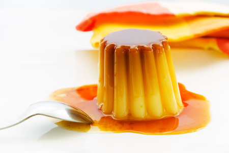Caramel pudding on white plateの写真素材