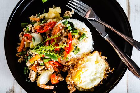 Thai spicy food basil pork fried with rice and fried egg ,Pad Kra Phao mooの写真素材