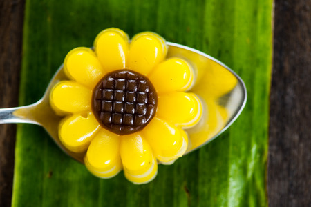 Yellow jelly dessert looking like a flower made with coconuts and pumpkinの写真素材