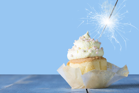 Cupcake with sparkler in blue and yellowの写真素材