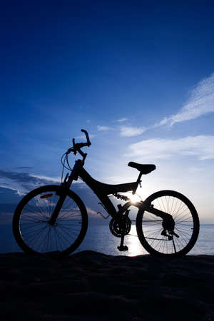 Silhouette of a Bike on the Beachの写真素材