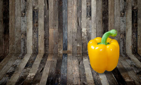 Yellow paprika on wooden backgroundの写真素材