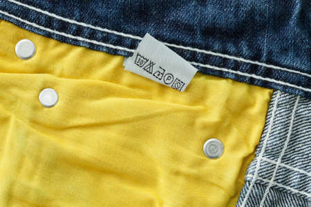 Laundry advice care symbols on blue jeans