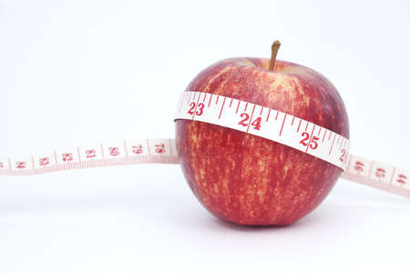 Fresh apple with measuring tapeの写真素材