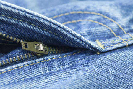 Close up of the blue jeans zipperの写真素材
