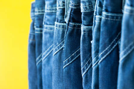 Row of hanged blue jeans in a shopの写真素材