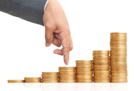 Business hand as finger walking on heap of coins