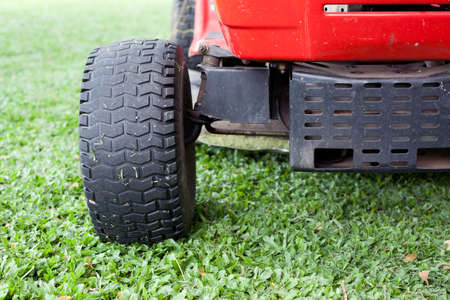 Lawn mower and green grassの写真素材