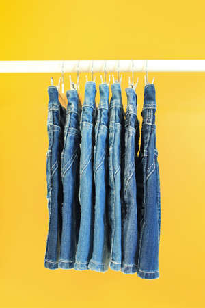 Row of hanged blue jeansの写真素材