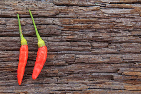 Hot chili peppers on old woodenの写真素材