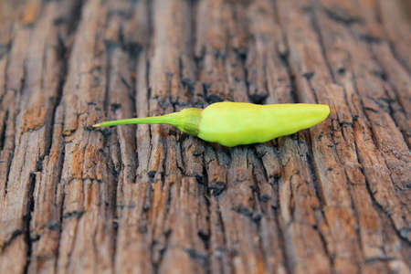 Hot chili pepper on old wooden backgroundの写真素材