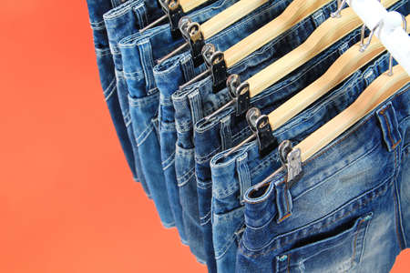 Row of hanged blue jeansの写真素材