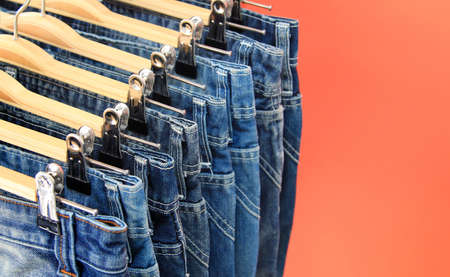 Row of hanged blue jeansの写真素材