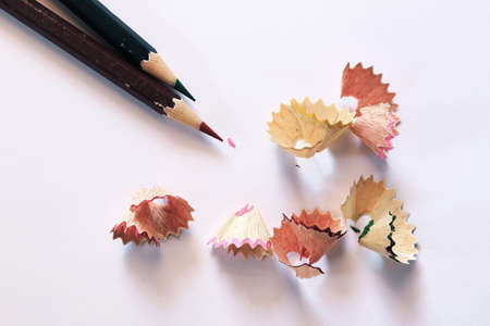 Pencils and pencil shaves on white paperの写真素材