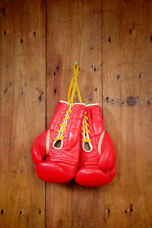 Boxing-glove hanging on wooden background