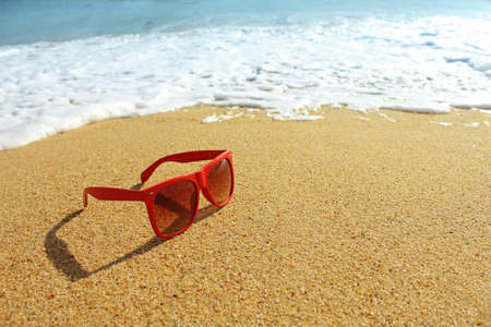 Red sunglasses on the beachの写真素材