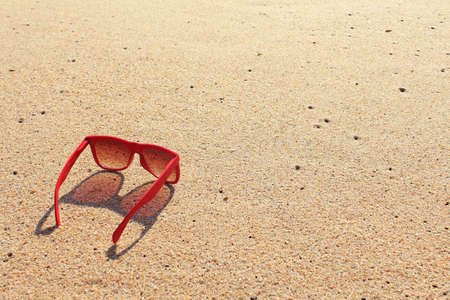 Red sunglasses on the beachの写真素材