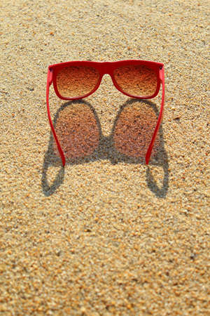 Red sunglasses on the beachの写真素材