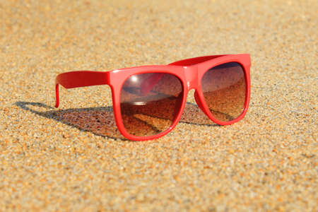 Red sunglasses on the beachの写真素材