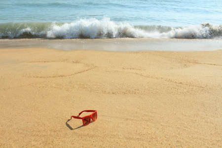 Red sunglasses on the beachの写真素材