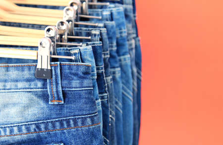 Row of hanged blue jeansの写真素材