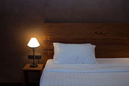 Desk lamp with pillow and bedの写真素材