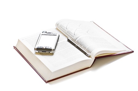 Open book, a pen and a PDA lying above, isolated on whiteの写真素材