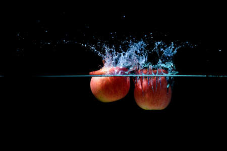 Red apple water splash.の写真素材