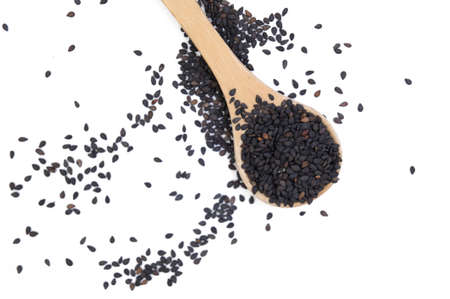 black sesame on wooden spoon on white backgroundの写真素材