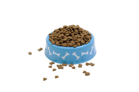 Dried pet food in blue bowl isolated on white background.の写真素材