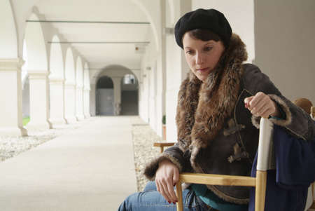 a young dark haired woman in a chair
