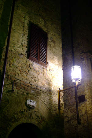 a latern on a brickswall during nightの写真素材